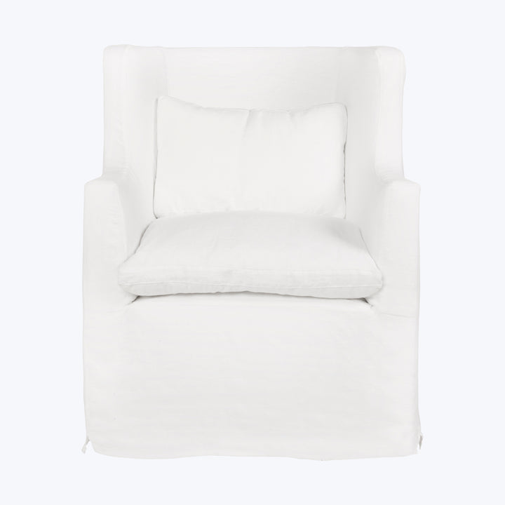 Contemporary white armchair with slipcover and loose pillow for comfort.