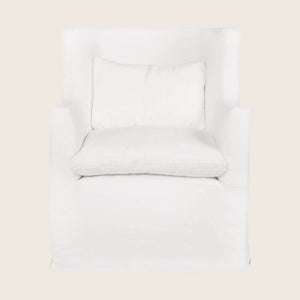 Contemporary white armchair with slipcover and loose pillow for comfort.