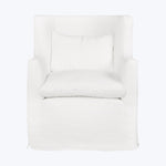 Contemporary white armchair with slipcover and loose pillow for comfort.