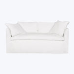 Minimalist white sofa with sleek design and soft fabric cushions.