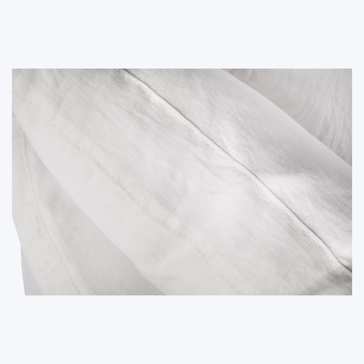 High-quality white fabric with visible threads and subtle shading variations.