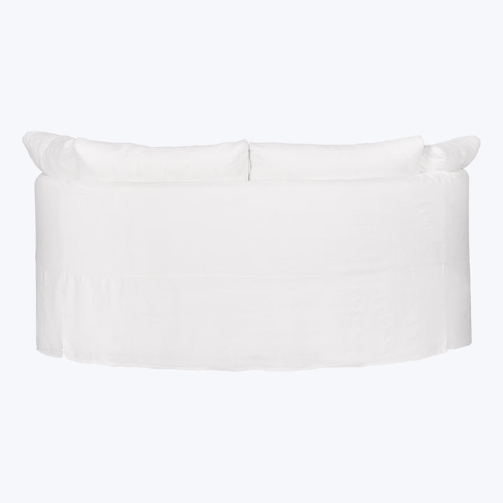 White slipcovered sofa with plush design, contemporary style, minimalist aesthetic.