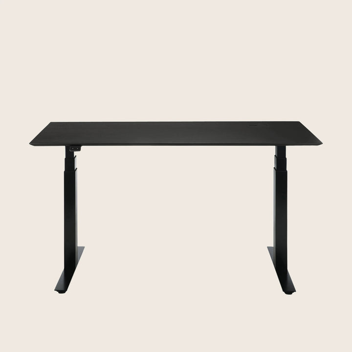 Modern standing desk with adjustable height legs and sleek design.