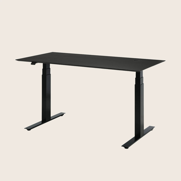 Minimalist black standing desk with sleek design and adjustable legs.