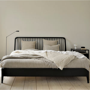 Modern wooden bed dressed in white bedding with mustard accents. - hover