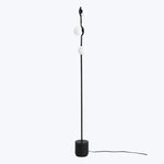 Modern floor lamp with minimalist design, featuring wavy pole.