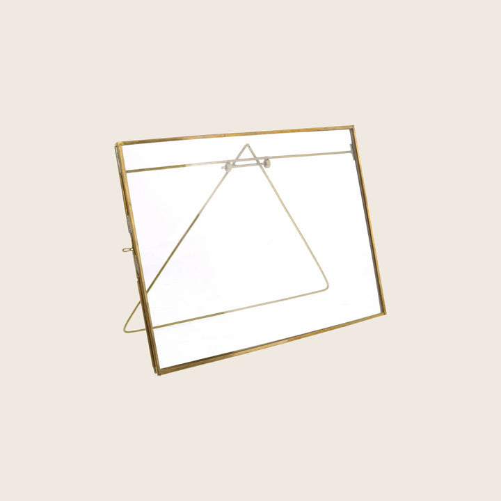Golden brass triangular metal frame with simple modern design decor.