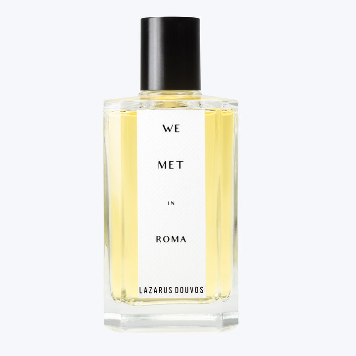 Elegant perfume bottle with WE MET IN ROMA label.