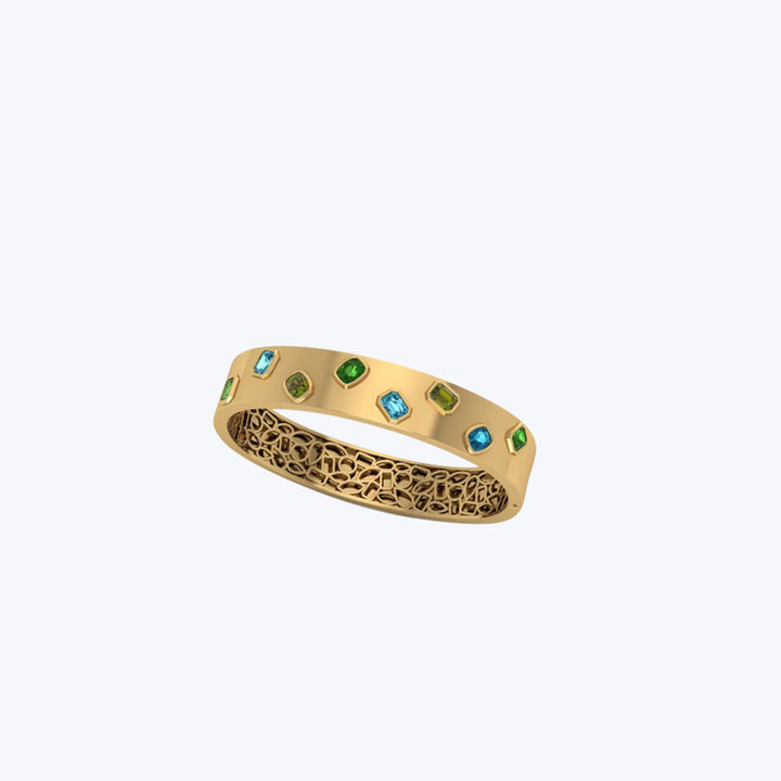 Elegant gold ring with green and blue gemstones and filigree.