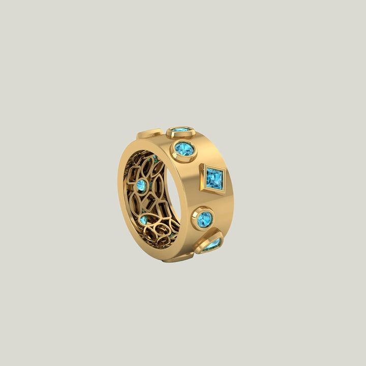 Luxurious golden ring with blue gemstones and intricate design.