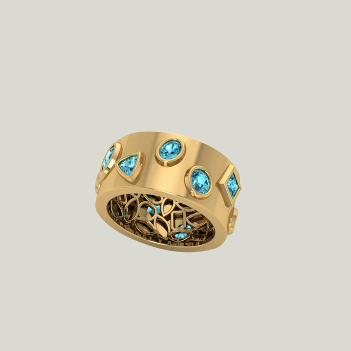 Elegant gold ring with blue stones in intricate design.