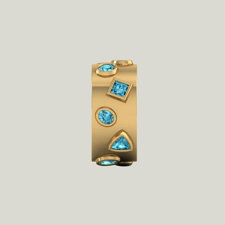 Gold jewelry with vibrant blue gemstones in symmetrical design.