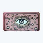 Rectangular clutch with stylized eye design on muted pink background.
