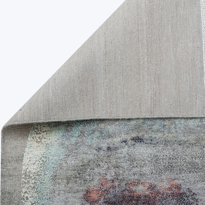 Close-up of two distinct textured surfaces: plain fabric and vintage rug.