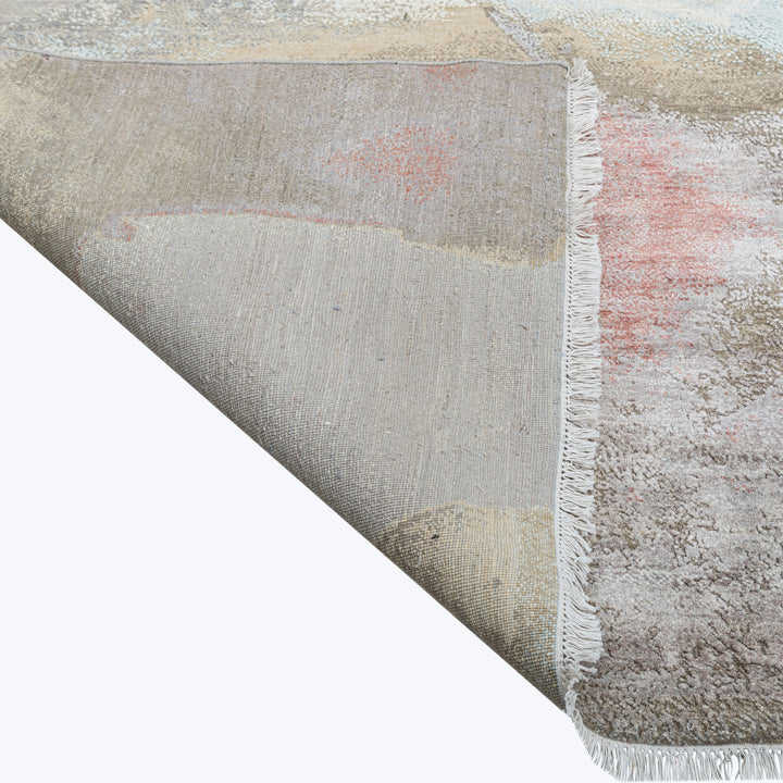 Vintage distressed rug with faded design, fringe detailing and soft texture.