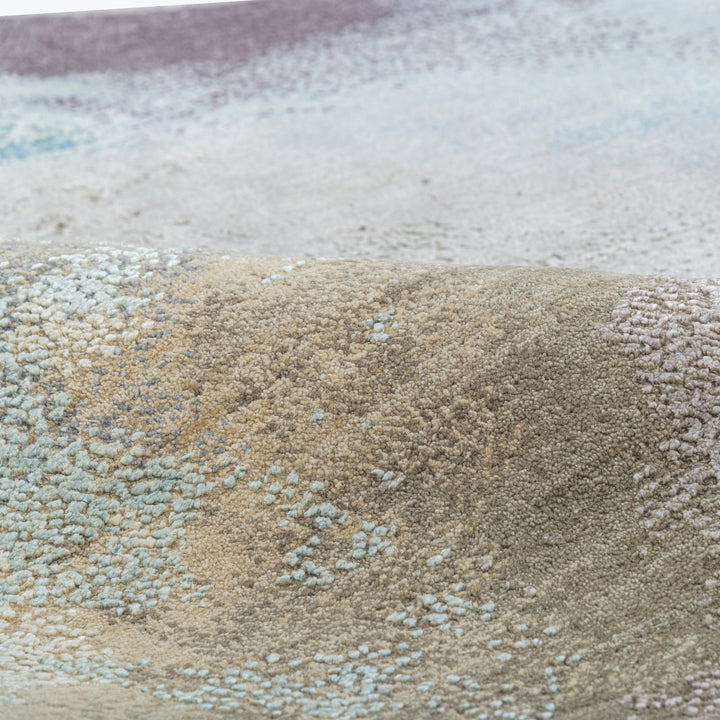 Close-up of intricately textured pile of colorful rolled carpets.