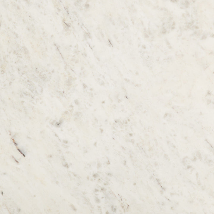 Close-up of creamy white marble with gray veining and speckling.