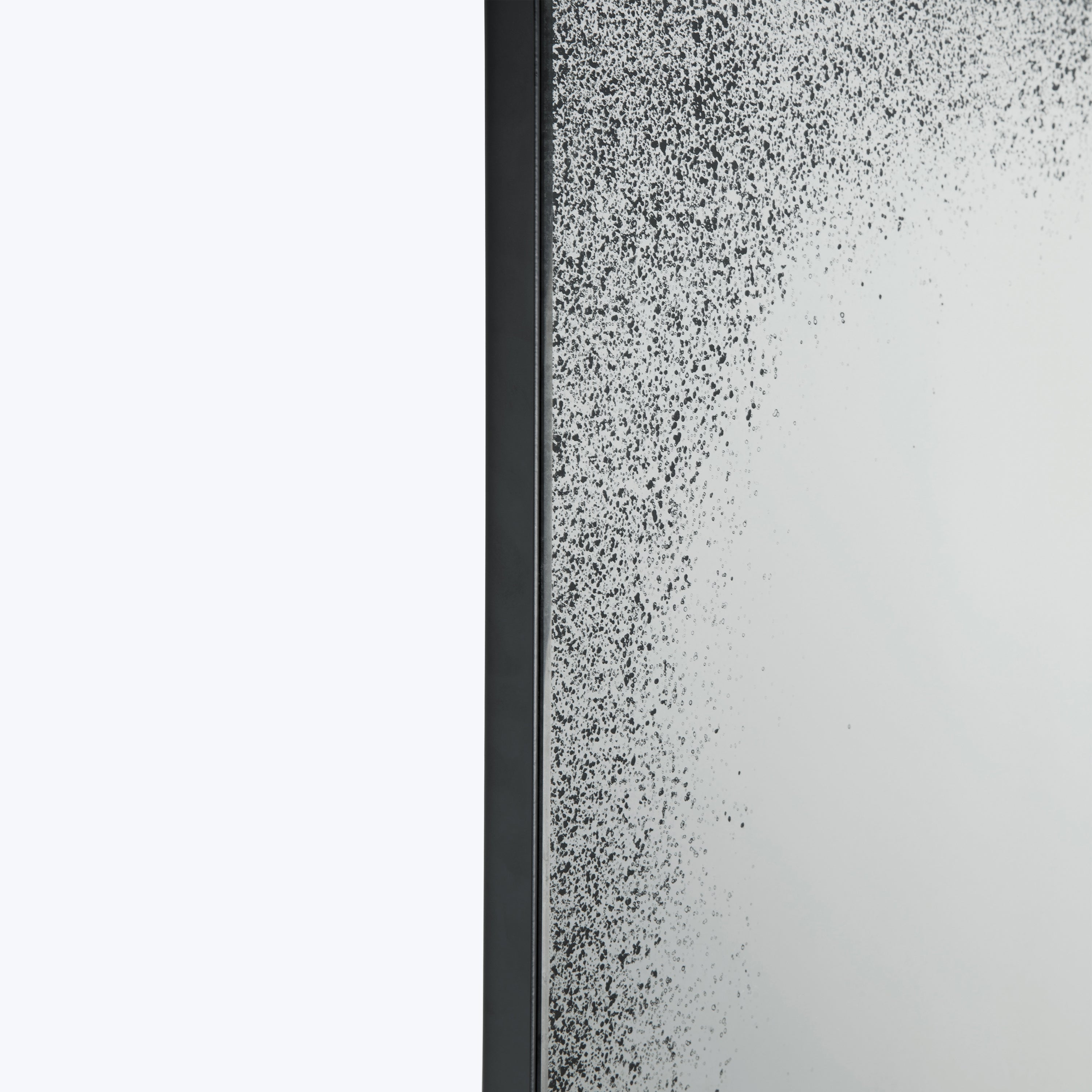 Close-up of dense black specks on vertical surface, possibly condensation