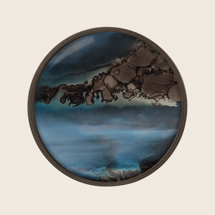 Abstract circular wall art with blue, brown, and black swirls.