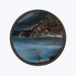Abstract circular wall art with blue, brown, and black swirls.