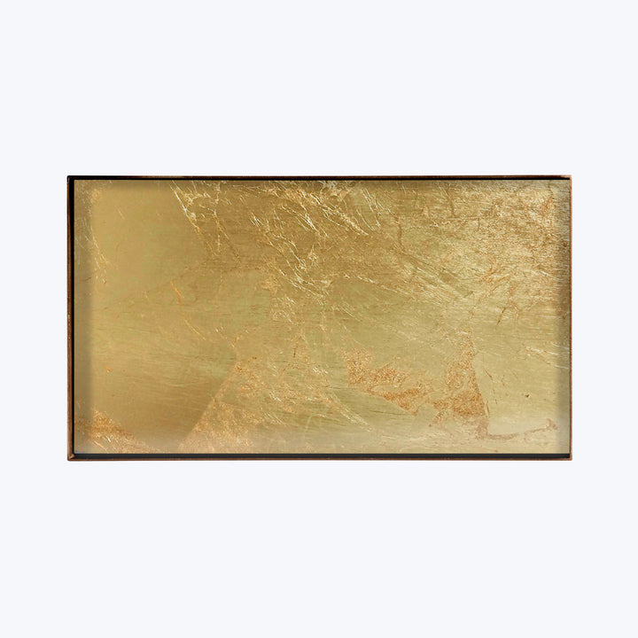 A textured gold rectangular object with scratches and scuffs.