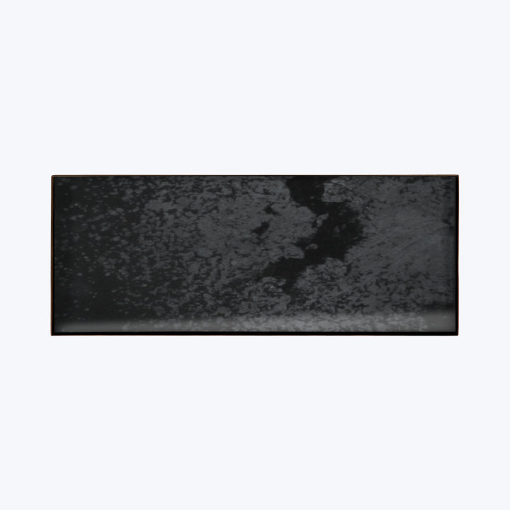 Abstract distressed texture in shades of gray and black.