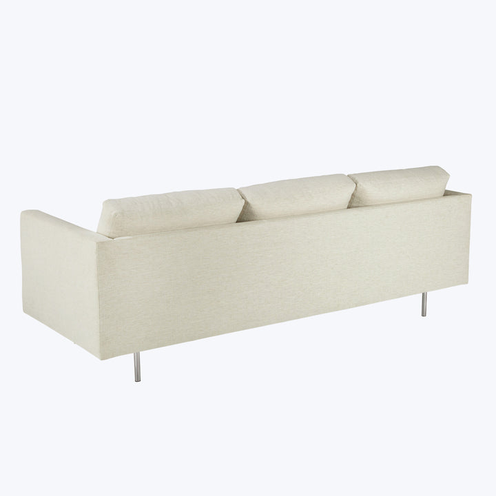 Modern three-seater sofa in light beige with minimalist design.