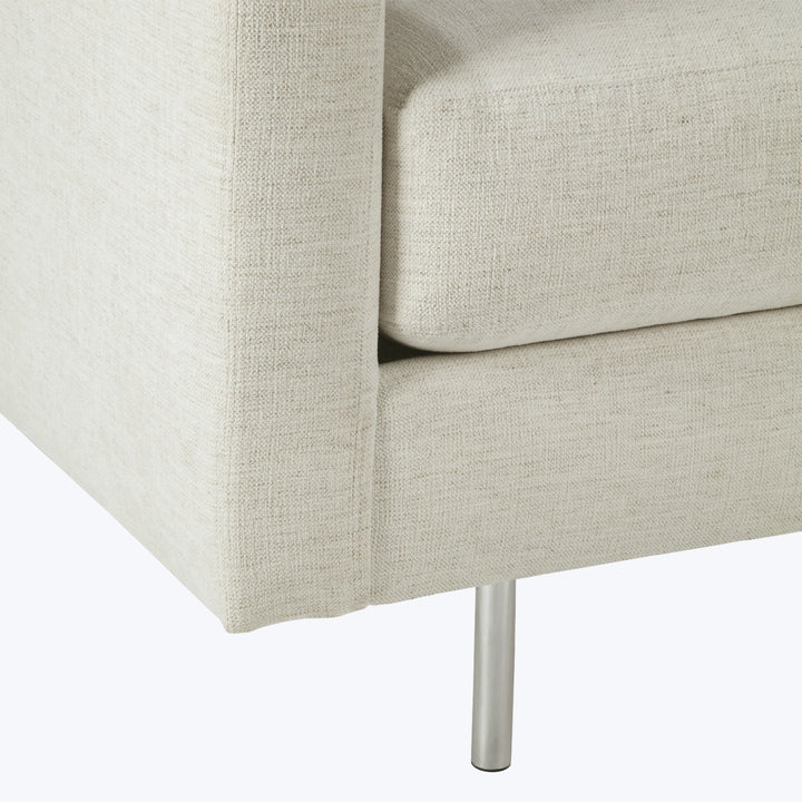 Modern beige fabric sofa with metallic leg, sleek minimalist design