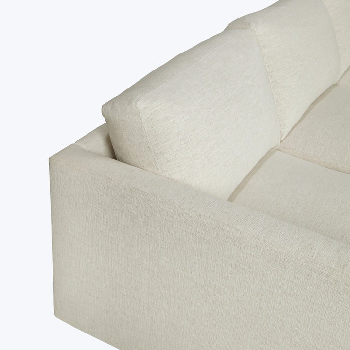 Neutral-toned sofa with textured fabric, clean lines, and quality craftsmanship.
