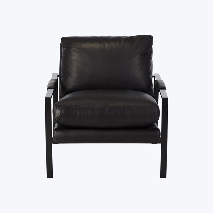 Minimalist modern armchair with black metal frame and leather upholstery.