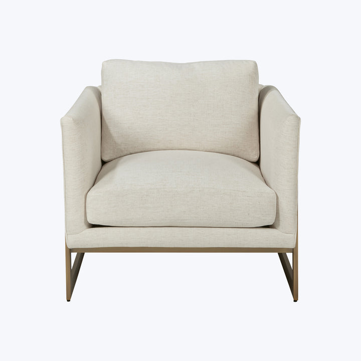 Modern single-seat armchair with cream upholstery and sleek metal legs.
