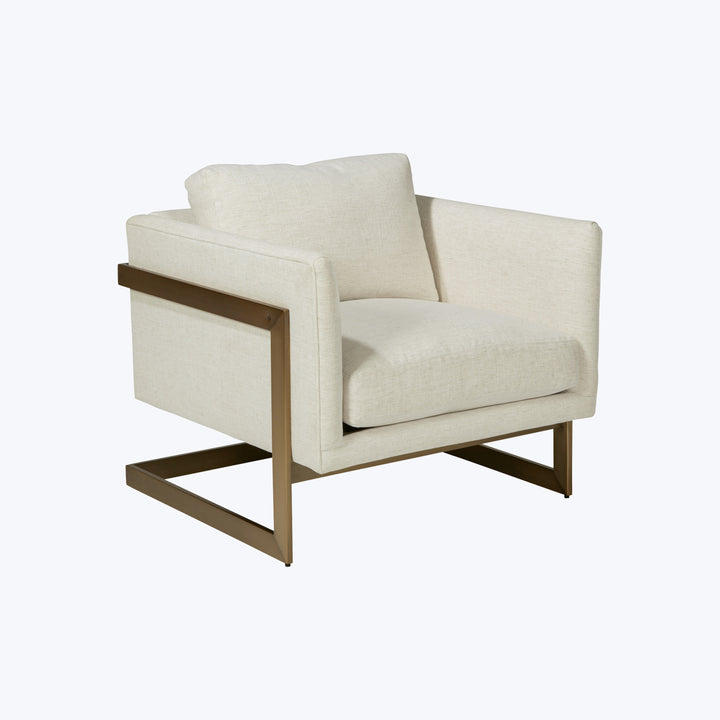 Modern armchair with cream upholstery, metal frame, plush cushions.