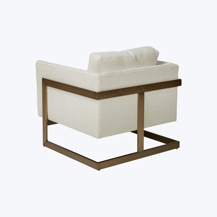 Modern armchair with minimalist design, metal frame, light upholstery cushion.