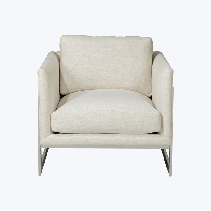 Modern armchair with beige fabric upholstery, minimalist design, metal legs.