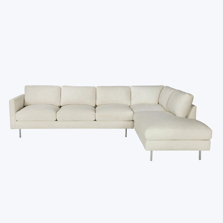 Modern sectional sofa with light upholstery and sleek metal legs