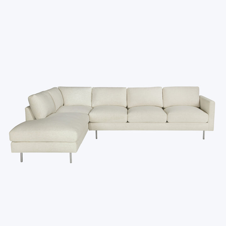 Modern sectional sofa with chaise lounge, light upholstery, sleek design.