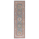 Vintage hall runner rug with ornamental medallions in warm tones.