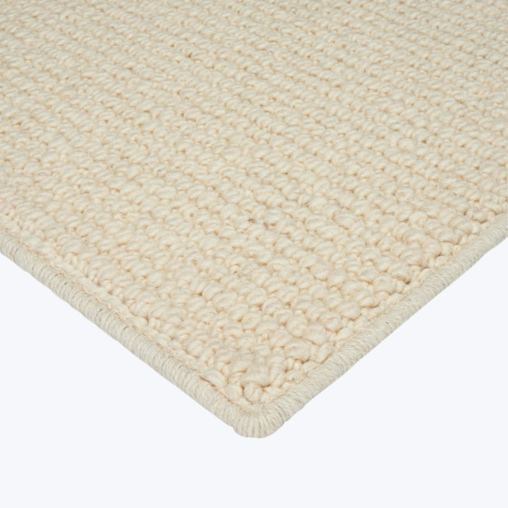 Close-up of plush loop pile rug in neutral beige color