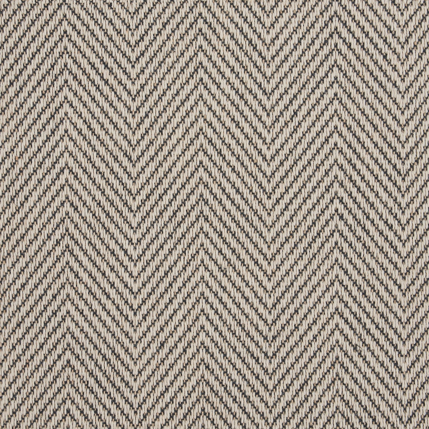 Close-up of herringbone pattern fabric in beige and brown tones.