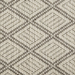Geometric textured fabric with diamond pattern in light and dark colors.