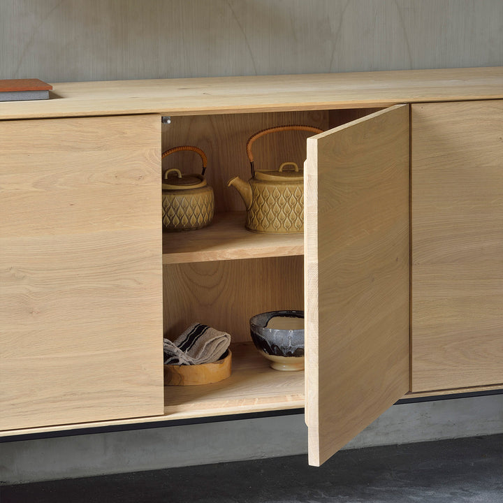 Modern wooden sideboard with open door, minimalist design, elegant decor.