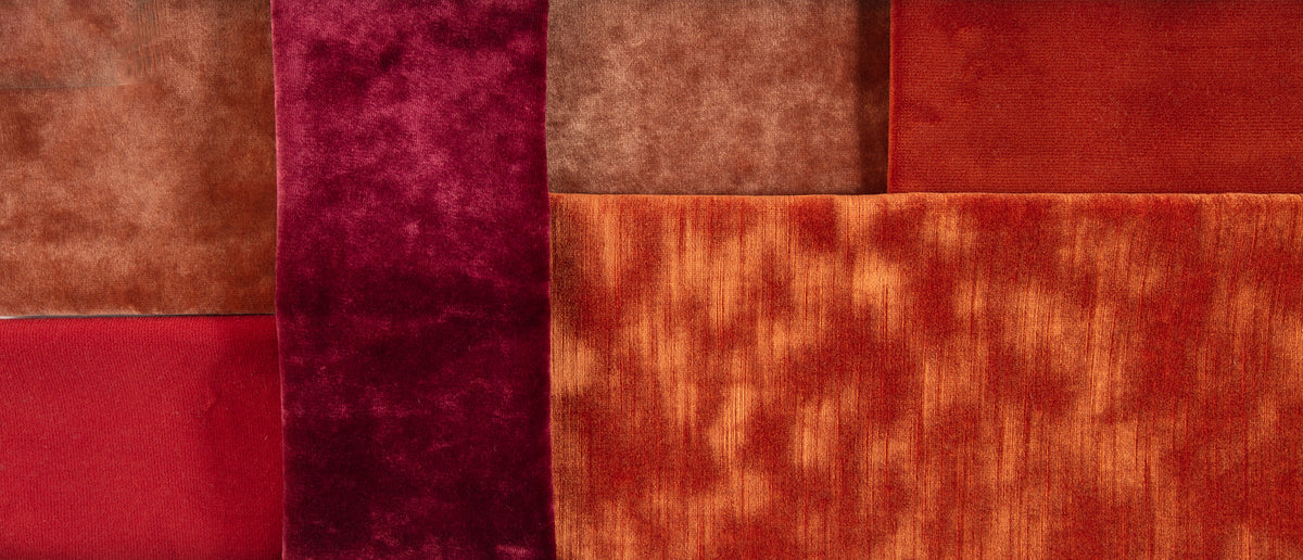 Assorted fabric samples showcase warm shades and textures for design.
