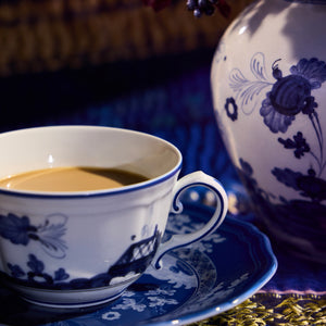 Porcelain pink teacup with floral design and elegant gold rim. - hover