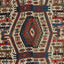 Colorful handwoven rug with intricate geometric design and symbolic elements.