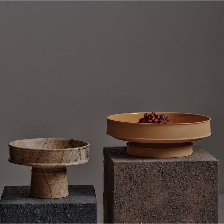 Still life with two bowls on stone pedestals, red grapes.