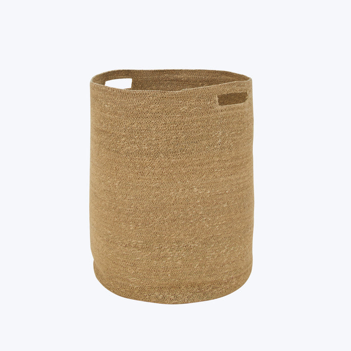 Simple tan cylindrical basket with cut-out handles and brand tag.