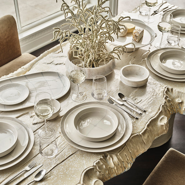 Elegantly set dining table with modern, rustic aesthetic and natural elements.