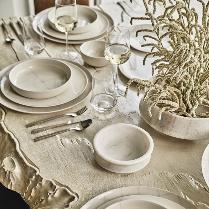 Elegantly set table with modern minimalist aesthetic, neutral color scheme.