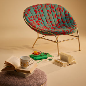 Modern golden chair with floral upholstery, sleek design for interiors. - hover