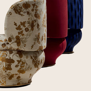 Plush armchair with ornate design, featuring vibrant floral upholstery. - hover